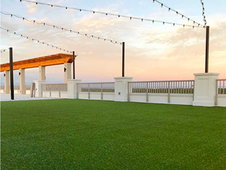 Turf surrounded by white fence